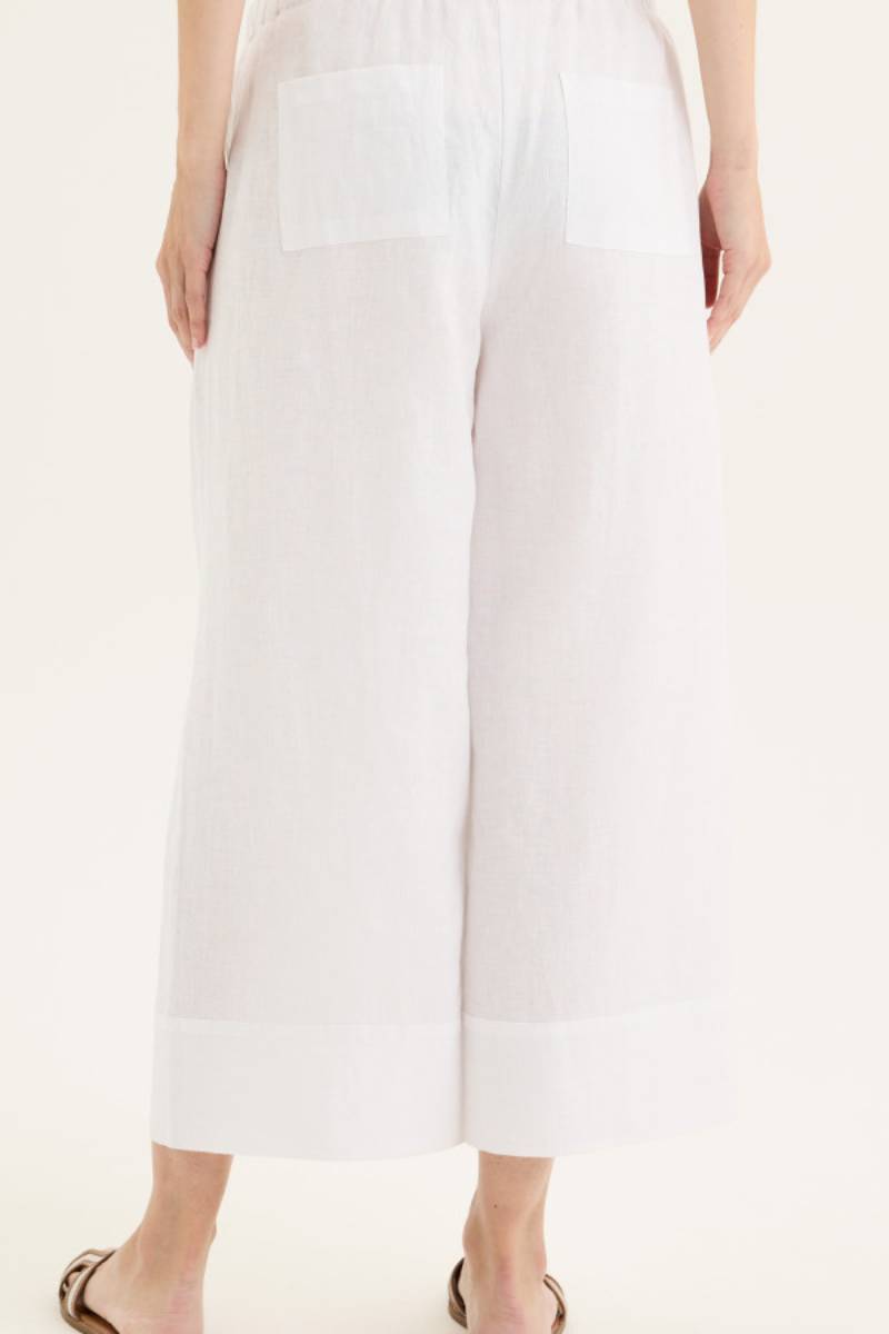 Back view of model wearing Yarra Trail Tirari Palazzo Pant in 100% linen — wide-leg 7/8 length style with elastic waistband and herringbone tie.