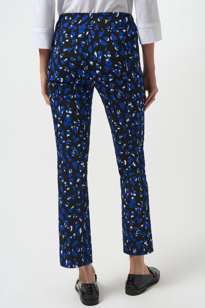 Back view of Blue patterned pants worn by a person on a white background