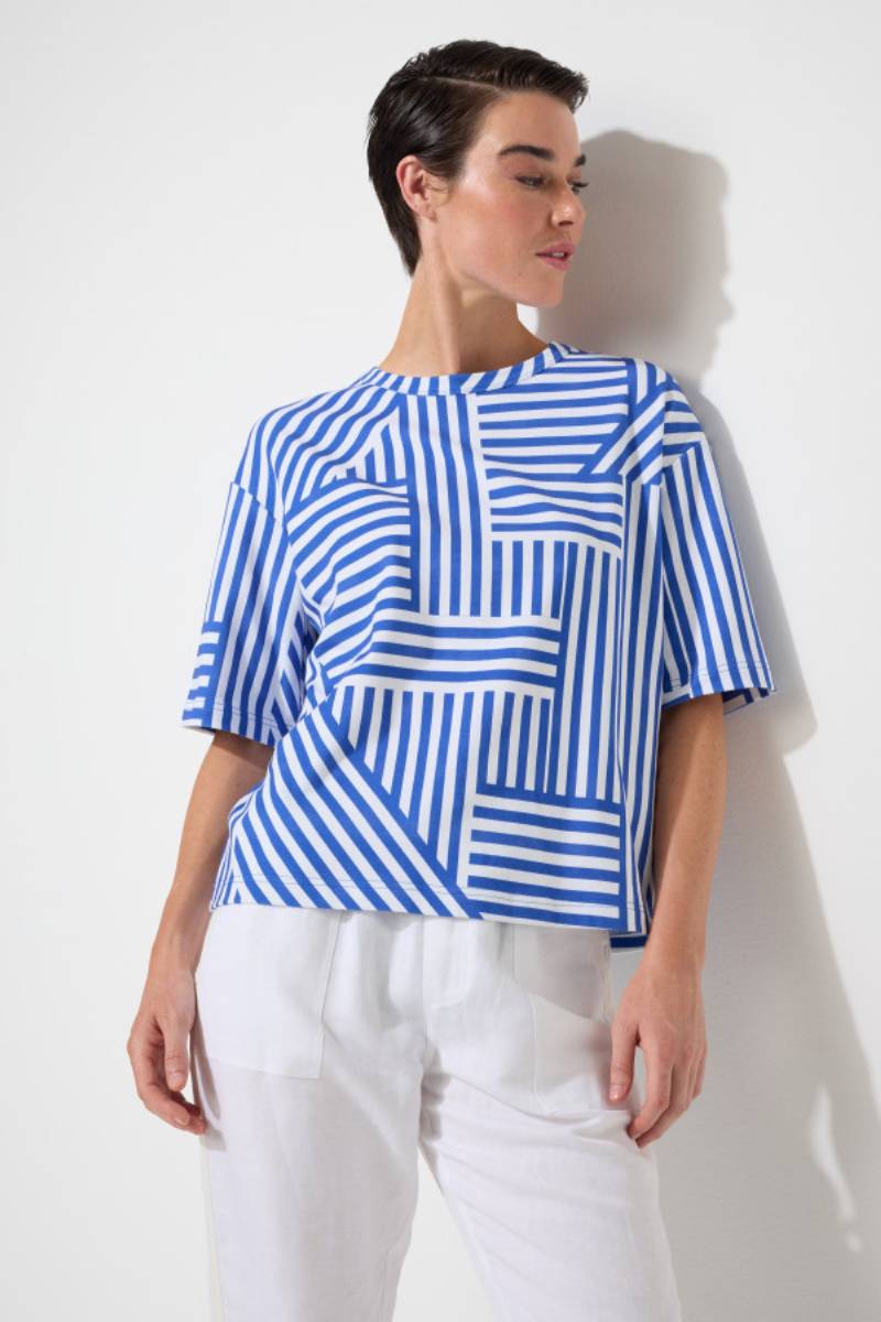 Model wearing the Marco Polo Spliced Stripe Tee — a soft cotton-elastane top with a contrasting spliced-stripe print, crew neckline, and elbow-length sleeves.