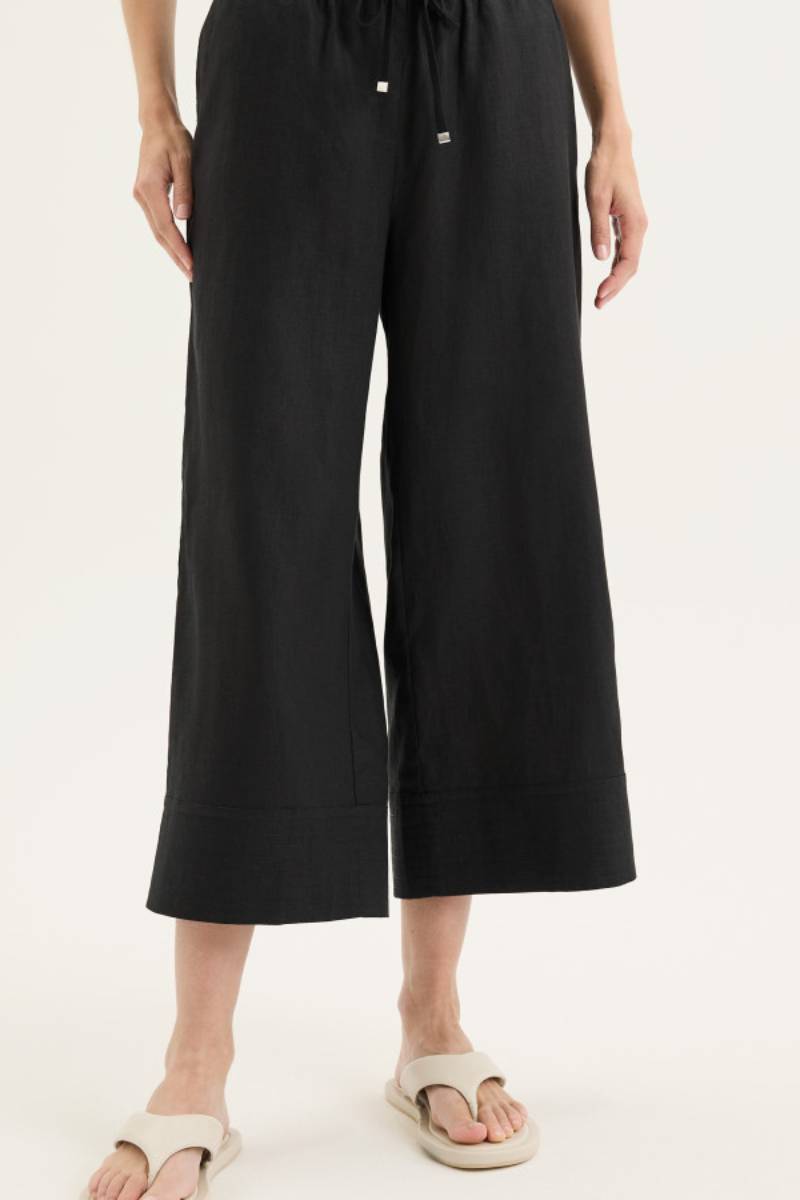 Front view of model wearing Yarra Trail Tirari Palazzo Pant in 100% linen — wide-leg 7/8 length style with elastic waistband and herringbone tie.
