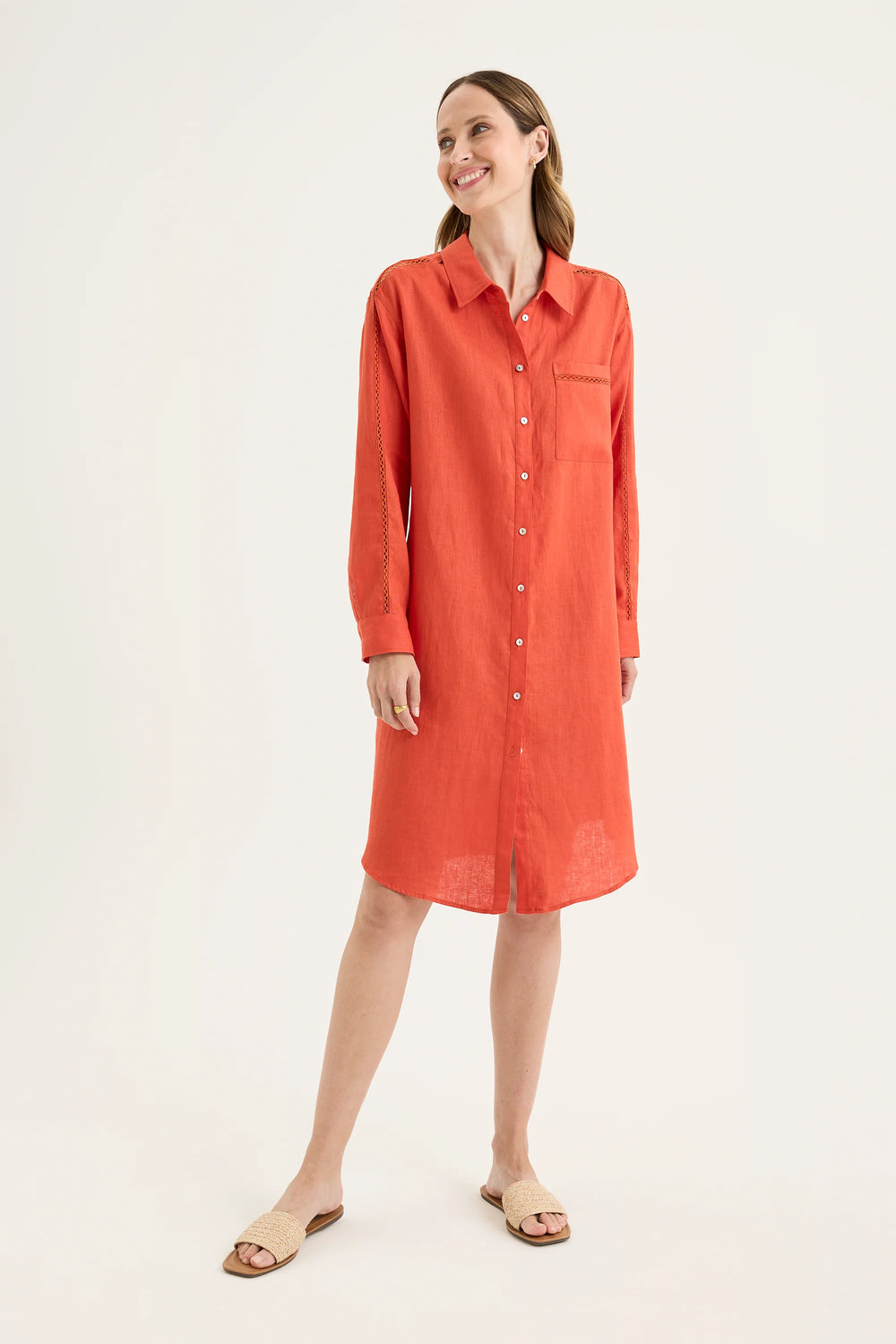 Woman wearing Tirari Shirtmaker Dress in Volcanic red by Yarra Trail YTWN9639 against a white background.