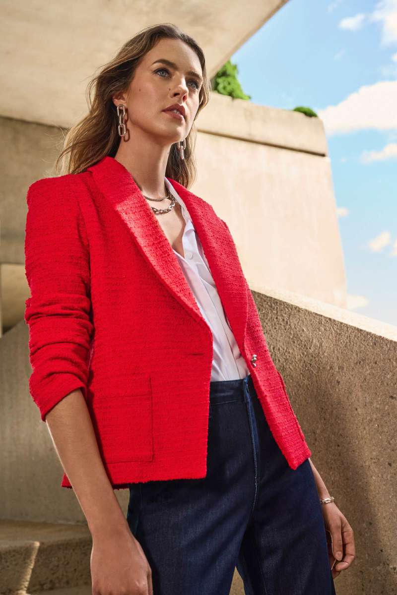 Woman Wearing Joseph Ribkoff Brooke Jeans In Indigo with the the boucle fitted blazer in radiant red and a white trapeze stretch shirt by joseph ribkoff front view