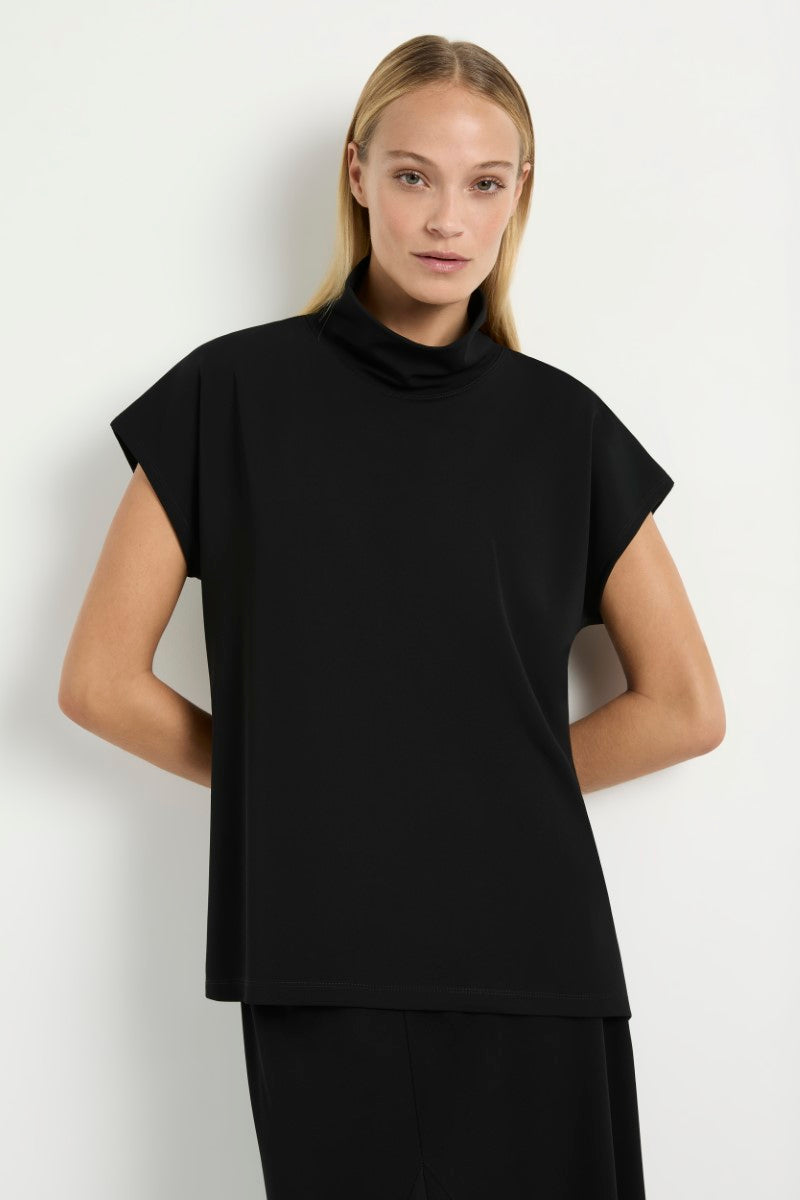Woman wearing Mela Purdie Funnel Shell in black F007 8233 with white background