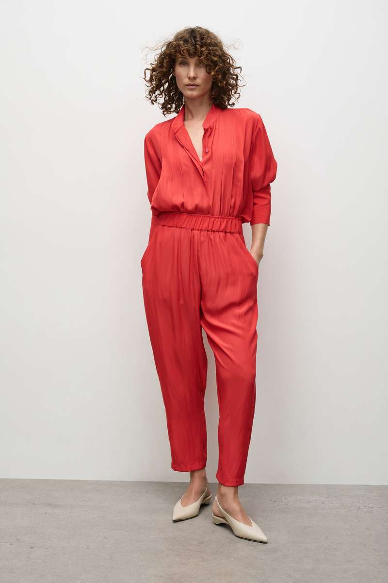Model in smooth pleat blouse tucked in