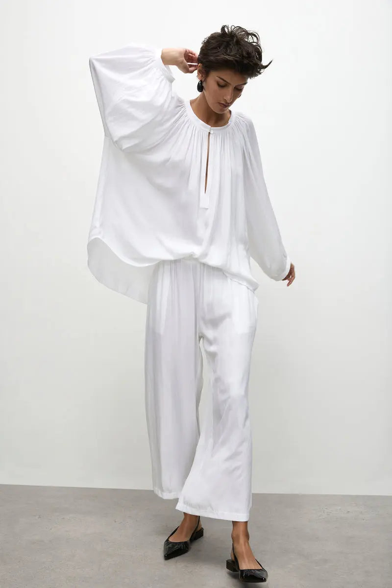 Woman wearing all white Mela Purdie Outfit