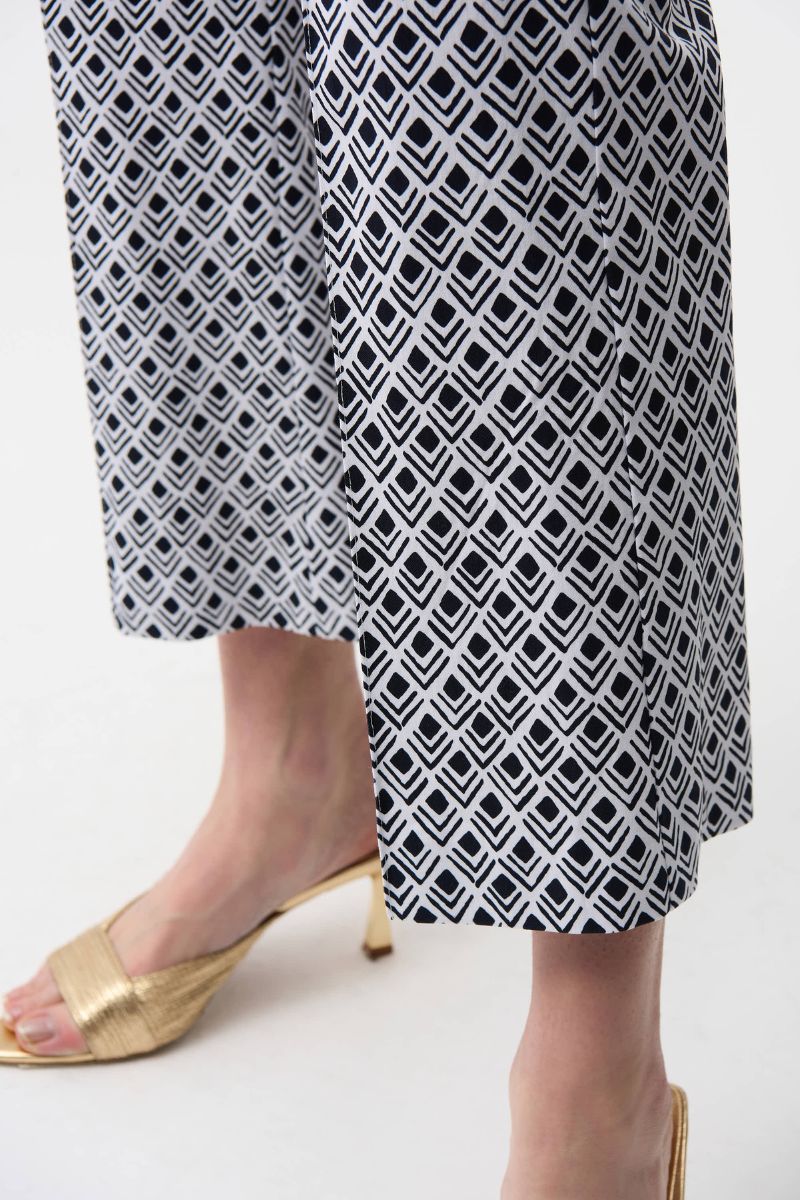 Woman wearing Joseph Ribkoff 261083 Millennium Flare Pants in Vanilla Midnight Print fabric and geometric print detail