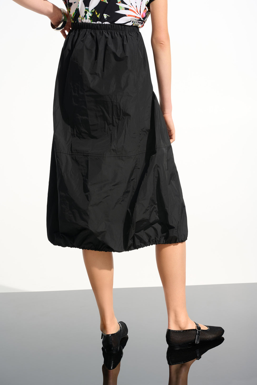 Woman wearing Joseph Ribkoff 261601 Memory Balloon Skirt with Elastic Waistband in Black back view