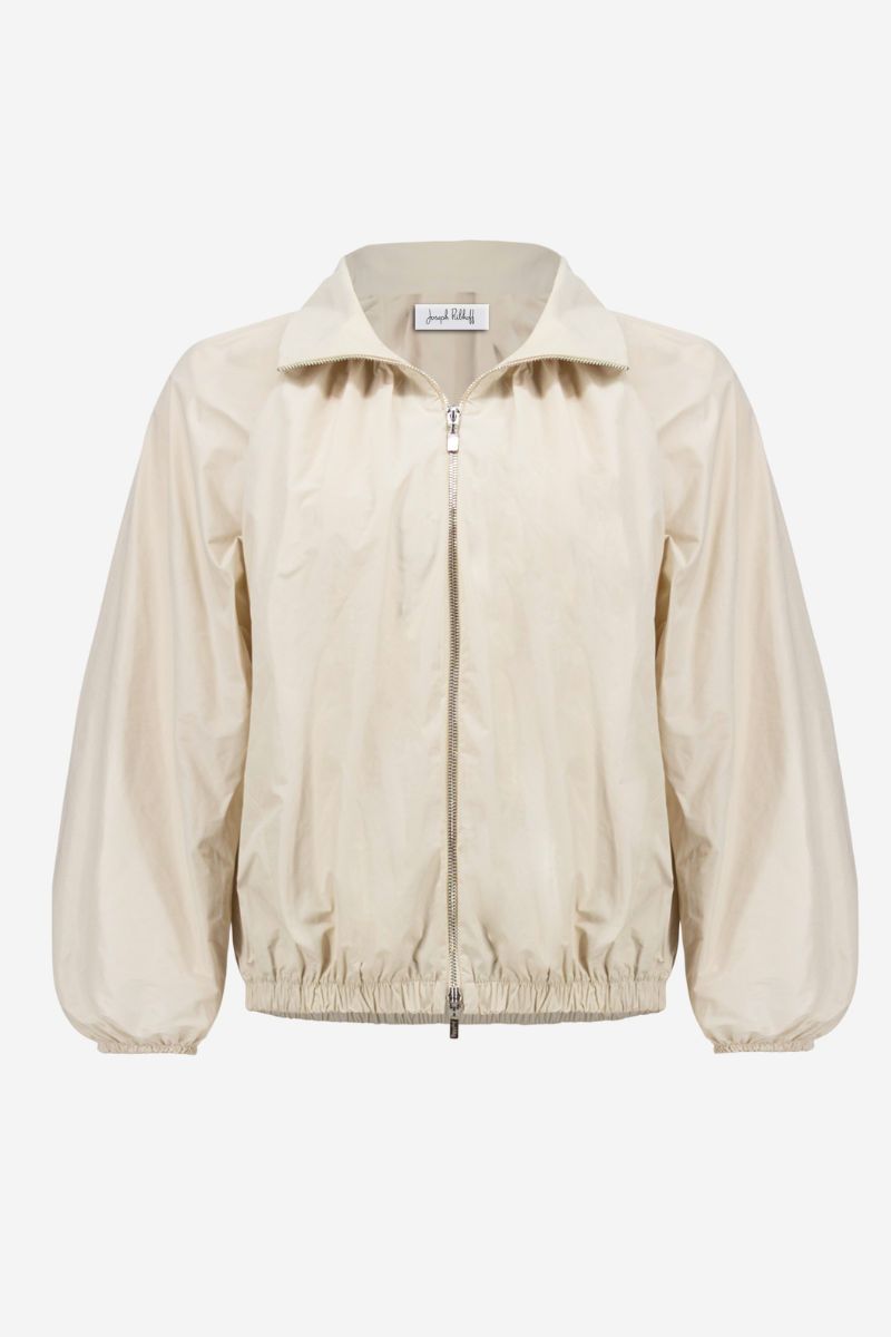 Woman wearing Joseph Ribkoff 261613 Memory Cocoon Outdoor Jacket fabric close-up in Moonstone