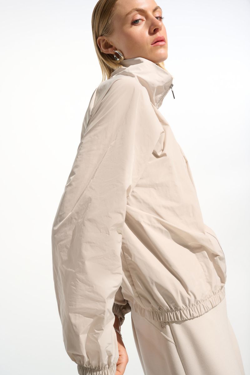 Woman wearing Joseph Ribkoff 261613 Memory Cocoon Outdoor Jacket side view in Moonstone