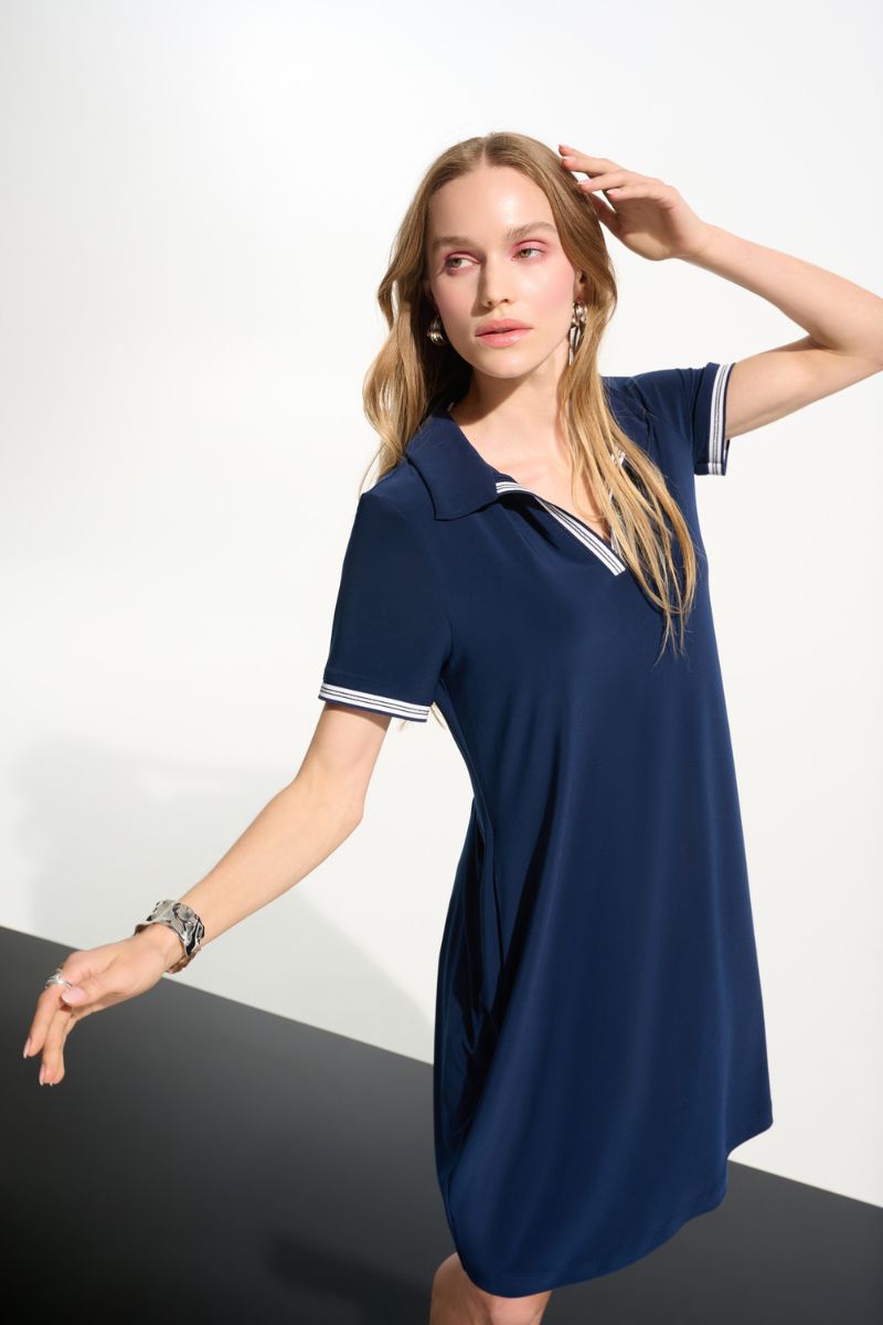 Woman wearing Joseph Ribkoff 261614 Silky Knit Trapeze Dress with Polo Collar fabric close-up in Indigo