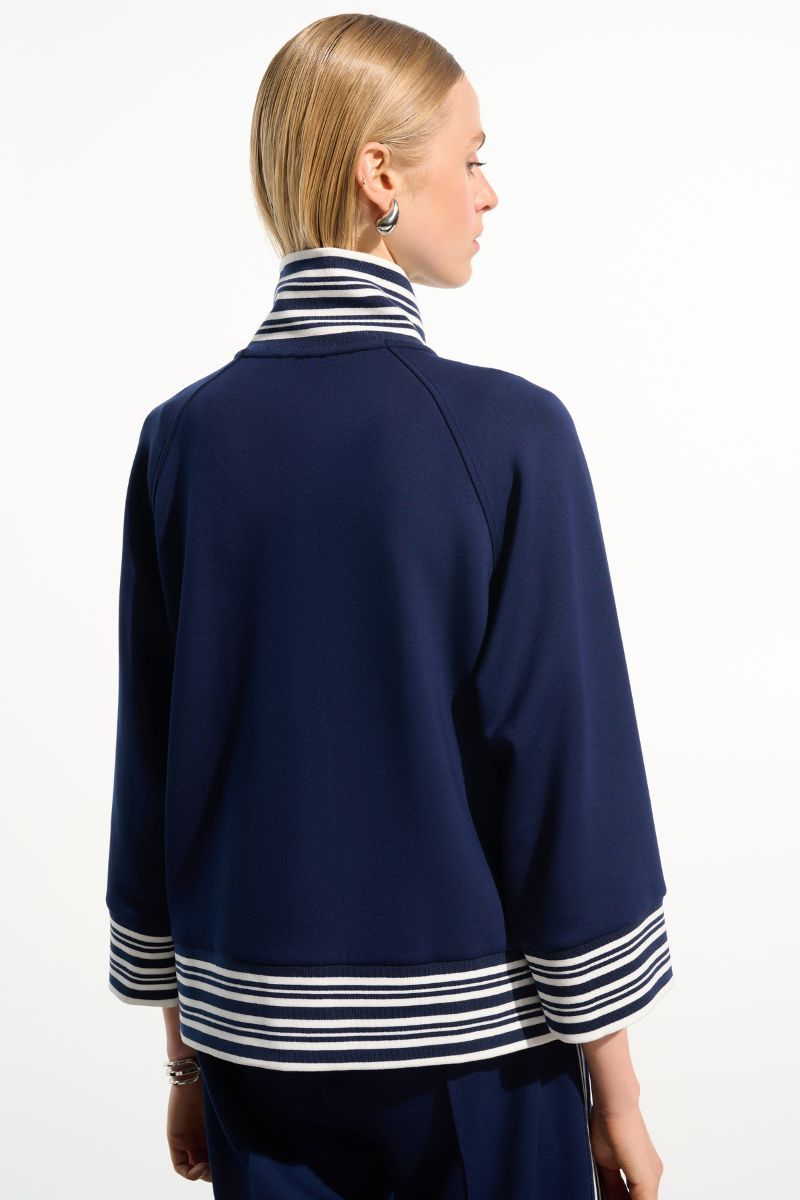 Woman wearing Joseph Ribkoff 261617 Scuba Jersey Jacket with Funnel Collar in Indigo Vanilla back view