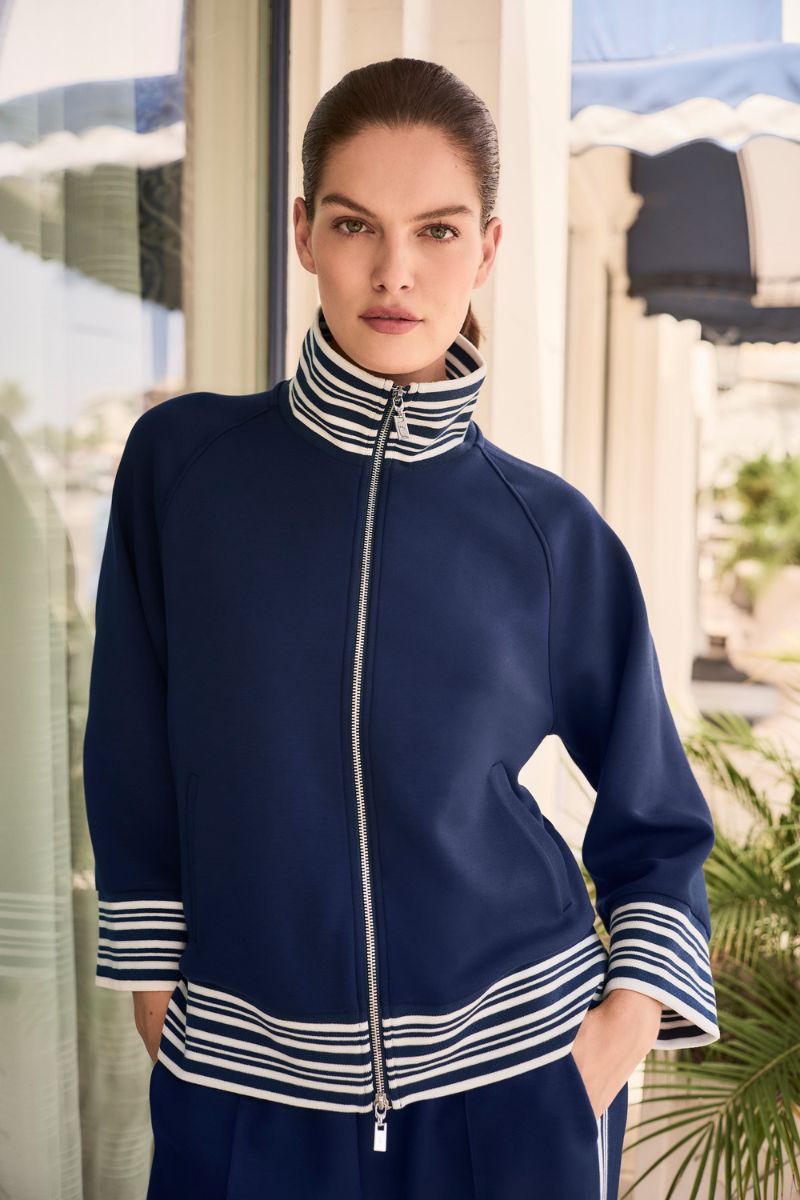 Woman wearing Joseph Ribkoff 261617 Scuba Jersey Jacket with Funnel Collar styled outfit view in Indigo Vanilla