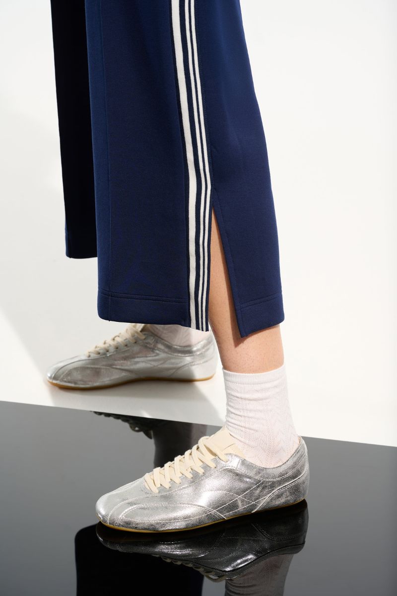 Woman wearing Joseph Ribkoff 261618 Scuba Jersey Pull-On Culotte Pants fabric close-up in Indigo Vanilla