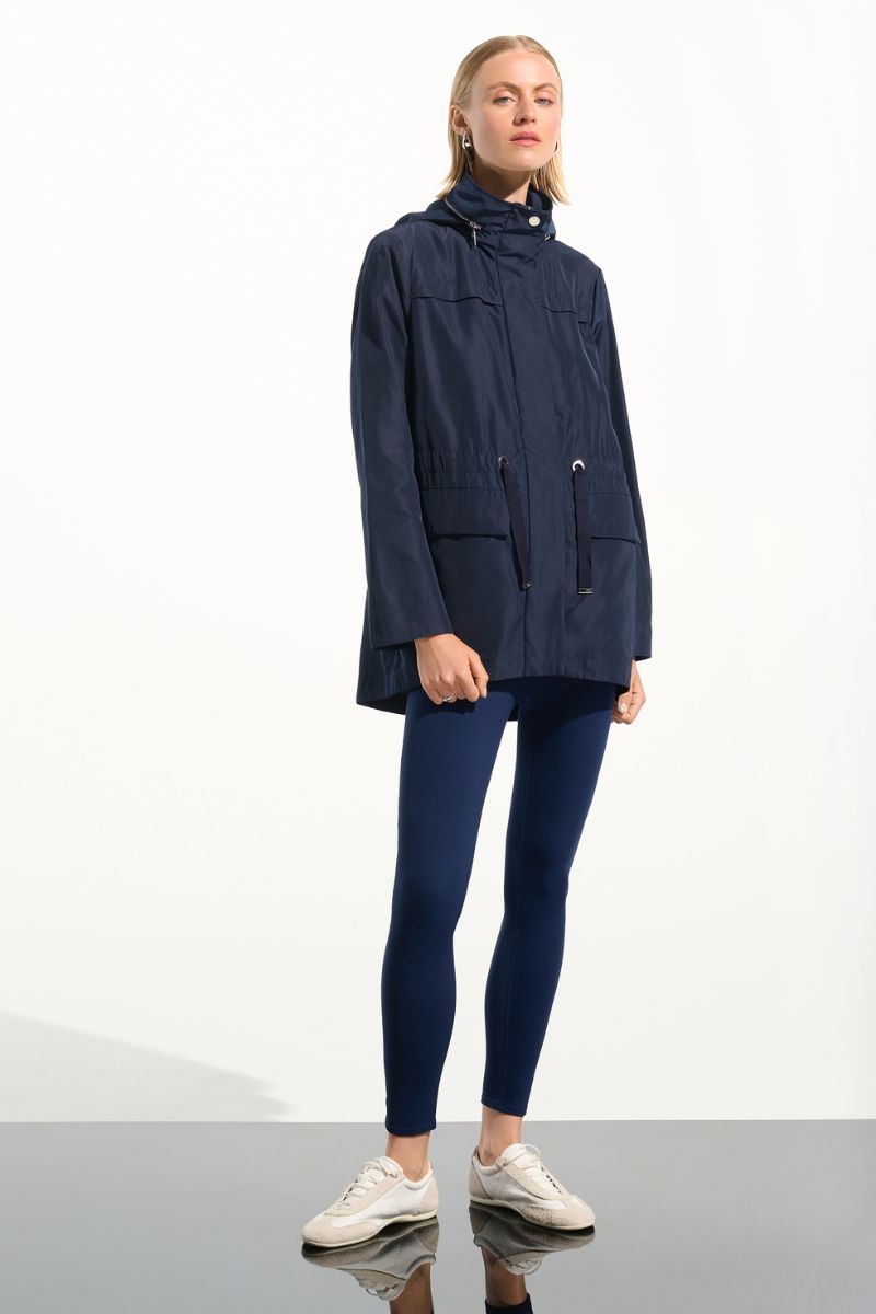 Woman wearing Joseph Ribkoff 261630 Imitation Memory Anorak with Hidden Hood side view in Indigo


