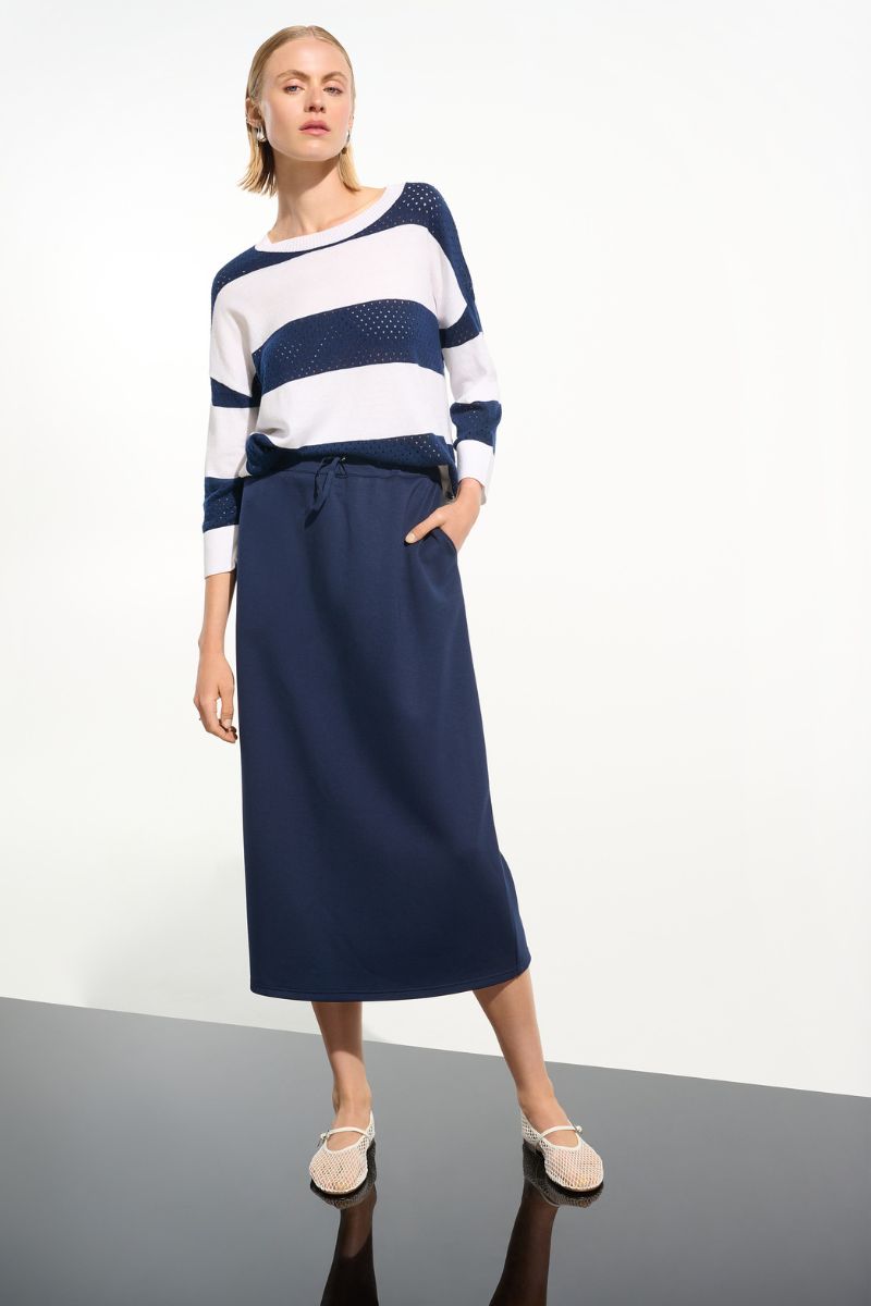 Woman wearing Joseph Ribkoff 261635 Cotton Blend Stripe Print Crewneck Sweater styled outfit view in Indigo Vanilla Stripe