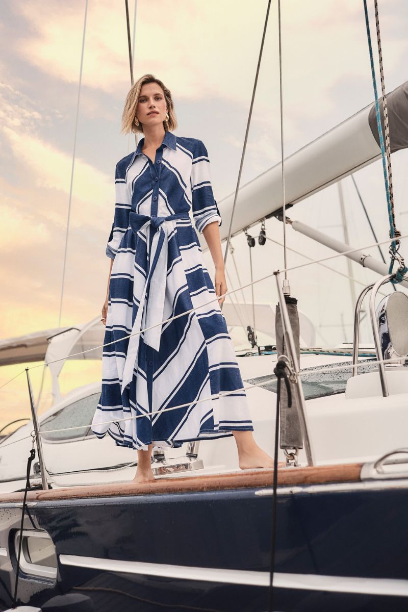 Woman wearing Joseph Ribkoff 261936 Cotton Stripe Print Fit and Flare Shirt Dress with Reversible Sash styled outfit view in Navy White Stripe