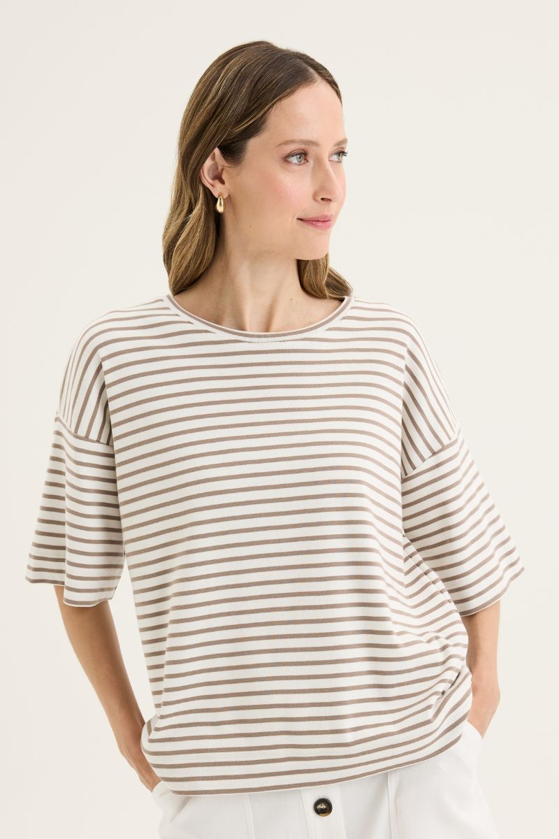 Woman wearing a striped shirt against a plain background