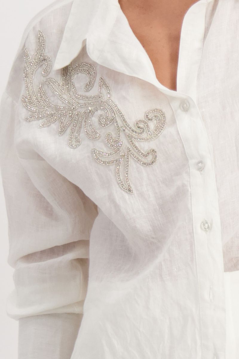 Woman wearing Monari 408982MNR embellished linen blouse appliqué detail in white