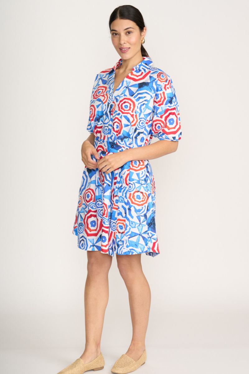 Woman wearing a colorful patterned dress on a white background