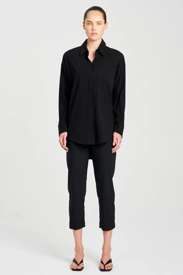Person wearing a black outfit on a white background