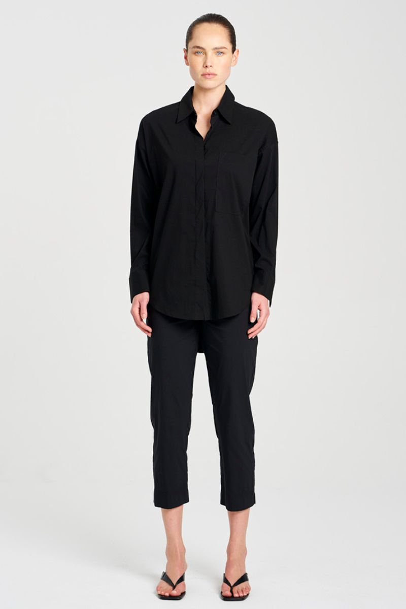 Person wearing a black outfit on a white background