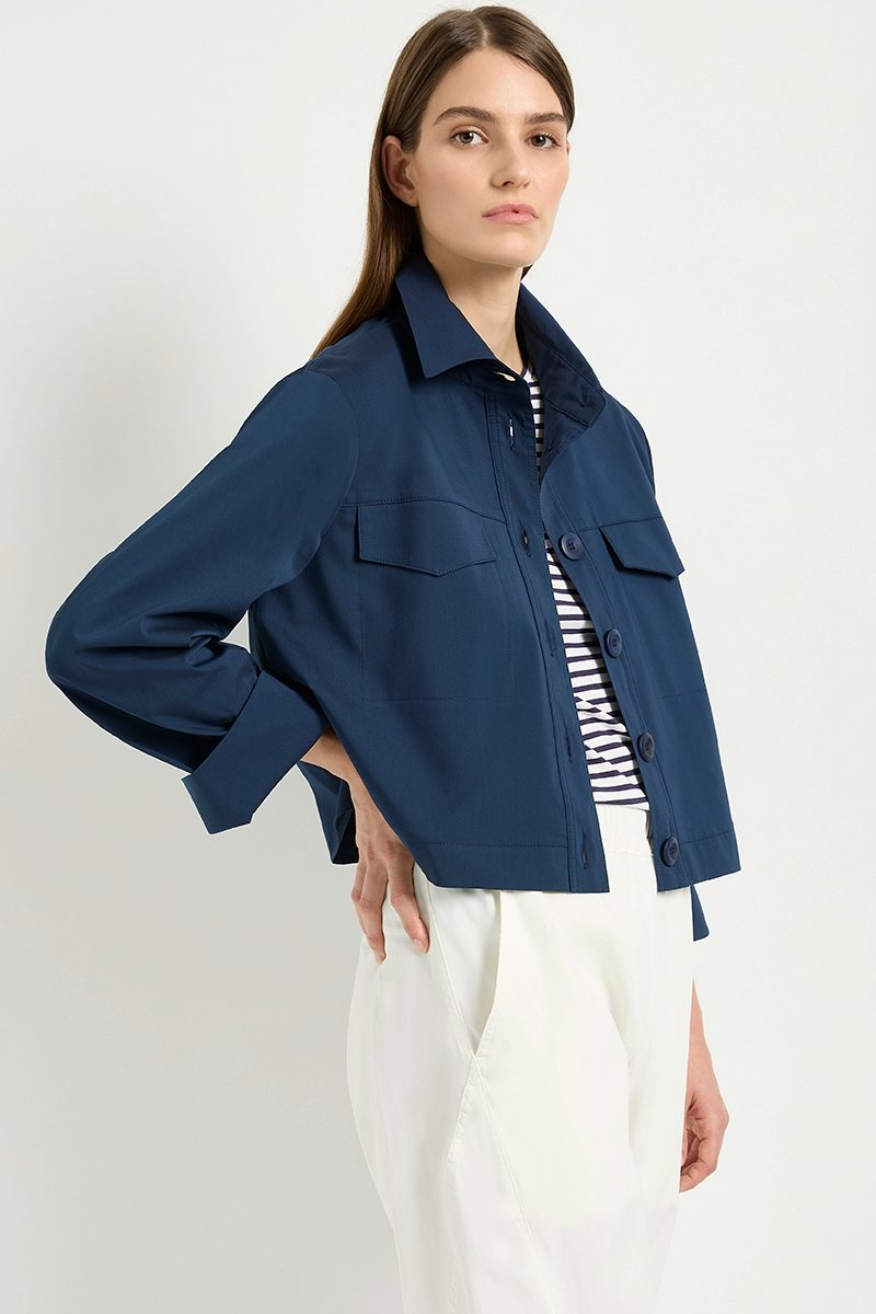 Woman wearing Trunk Jacket F65 4149 in Sapphire over a striped relaxed boat neck top and white cropped zip cargo pants F65 1386 by Mela Purdie with a white background