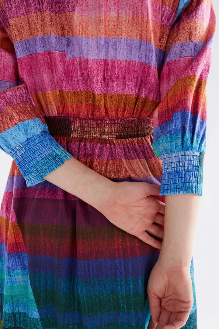Multicolored striped dress with a focus on the fabric pattern.