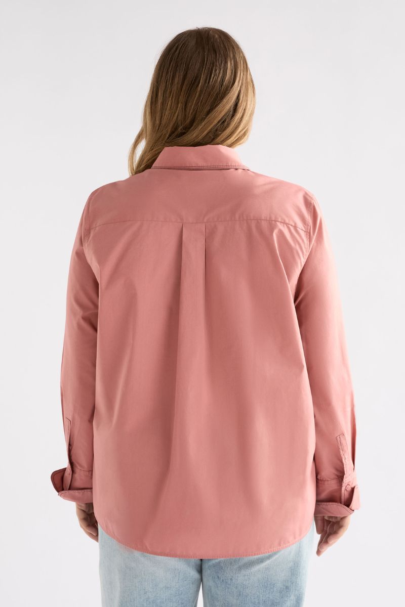 Back view of woman wearing a pink shirt on a white background