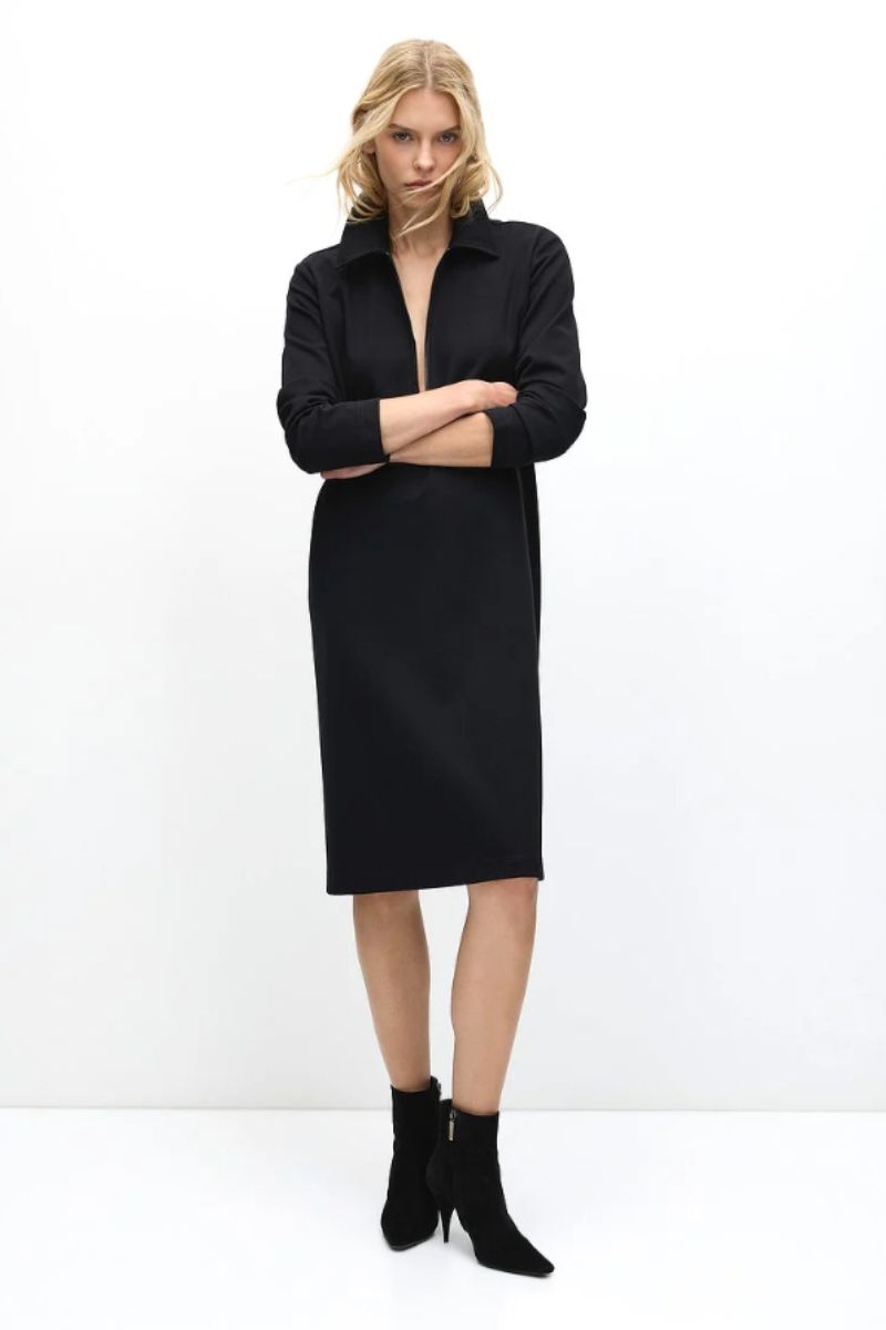 Model wearing zip collar dress front view arms crossed