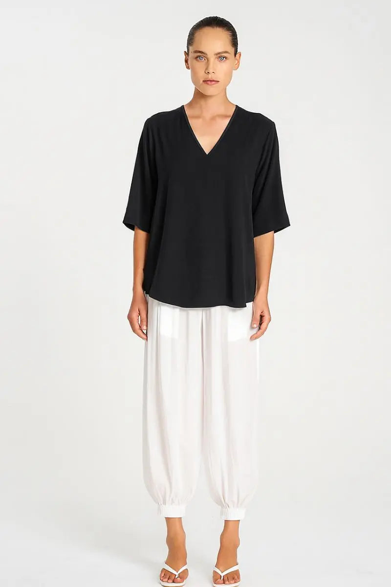 Woman wearing Mela Purdie F67 8839 Swish Plaza Top in Black front view