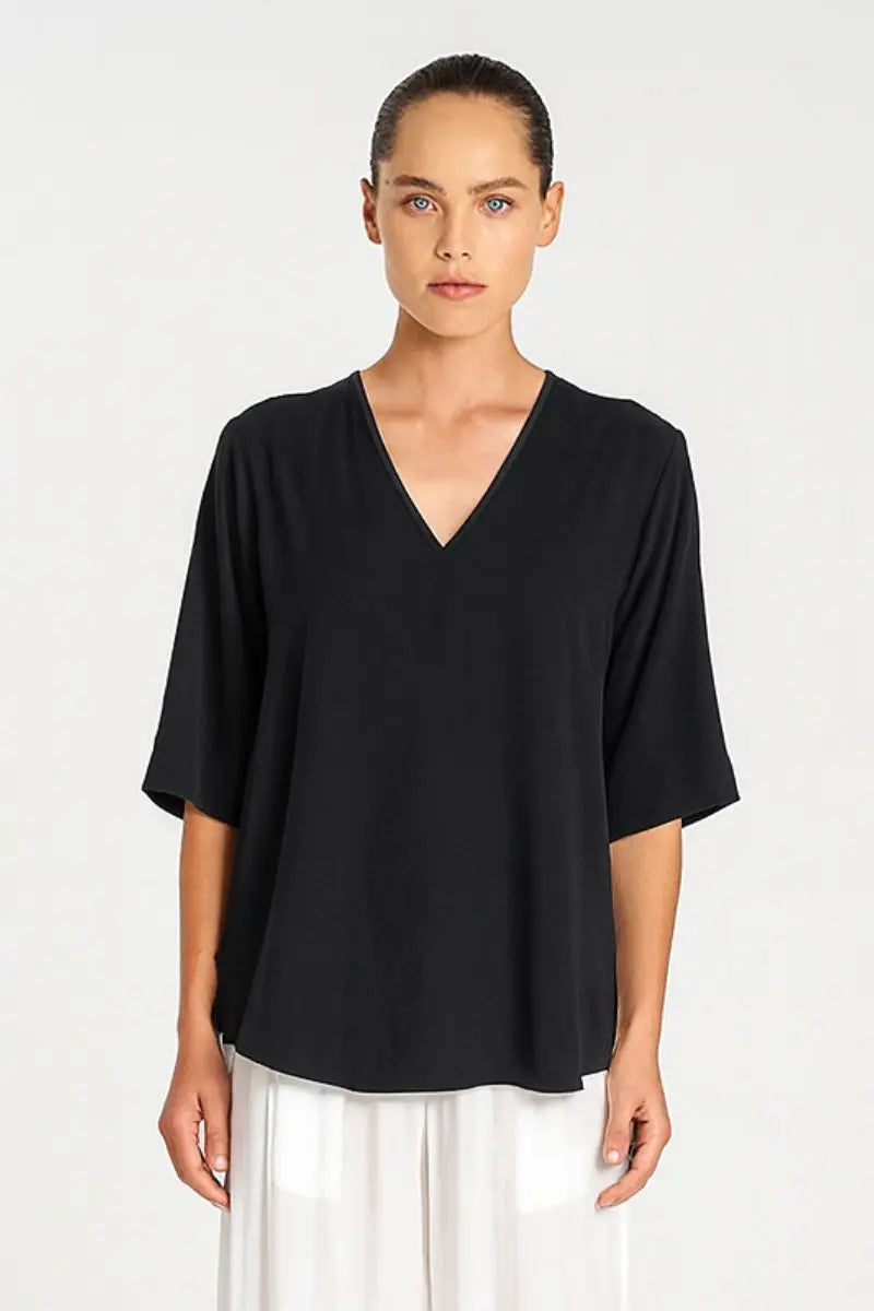 Woman wearing Mela Purdie F67 8839 Swish Plaza Top in Black neckline detail
