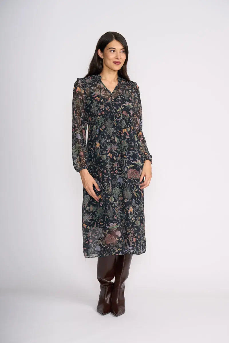 Woman wearing Tinder Twirl Dress in Narnia with a black background and multi pattern by FOIL FO8515 front view
