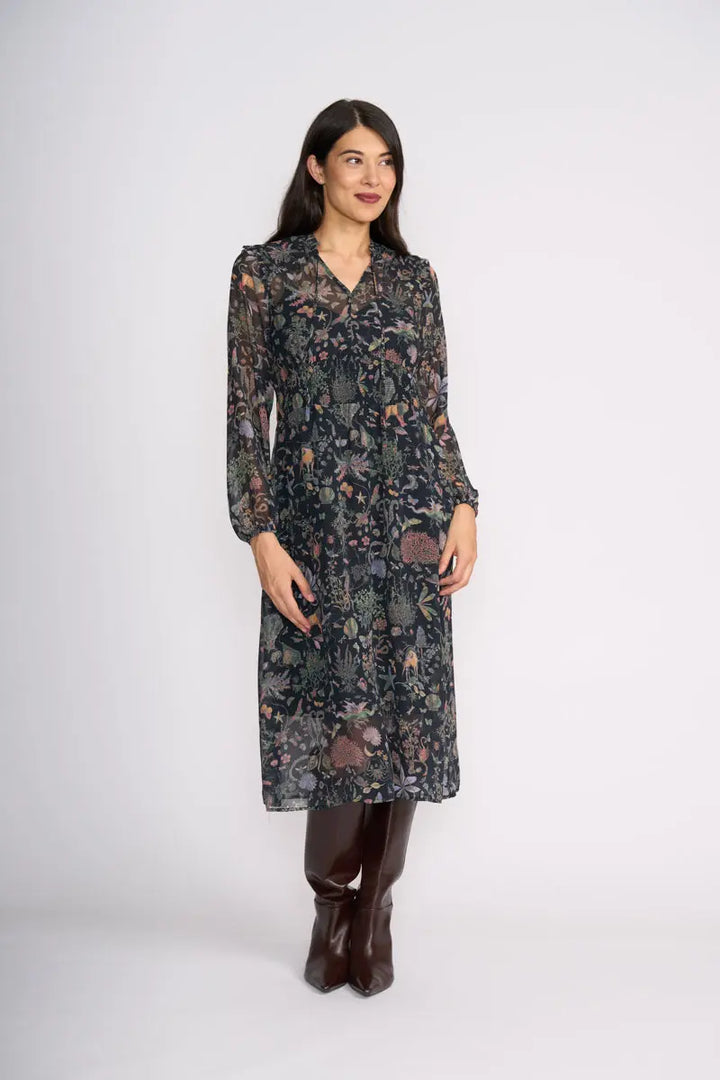 Woman wearing Tinder Twirl Dress in Narnia with a black background and multi pattern by FOIL FO8515 front view