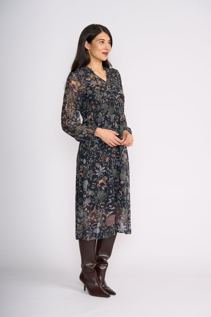 Woman wearing Tinder Twirl Dress in Narnia with a black background and multi pattern by FOIL FO8515 SIde view