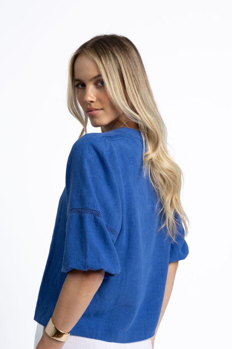 Woman wearing Humidity Lifestyle HS25200 Nixie Blouse Royal Blue side view