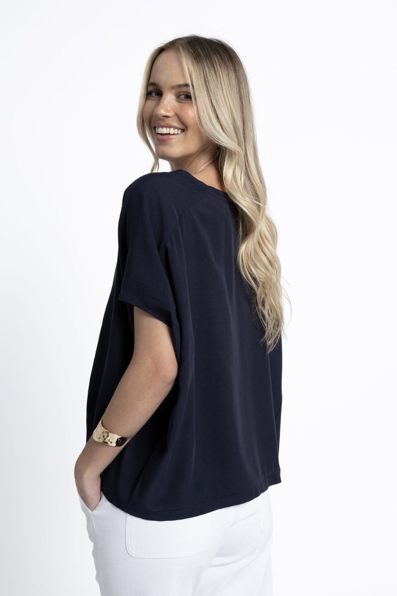 Woman wearing Humidity Lifestyle HS25243 Lush Top Navy side view