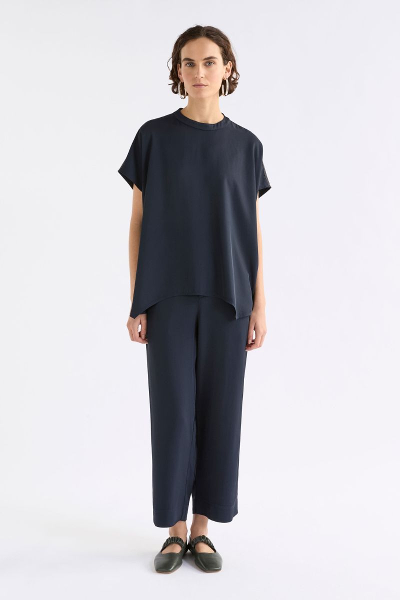 Person wearing a dark blue outfit on a white background