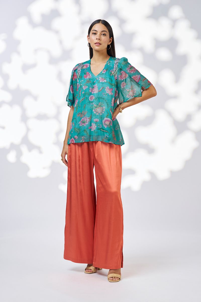 Woman wearing Loobies Story LS3114 Anaphora Blouse Aqua Multi print and fabric detail