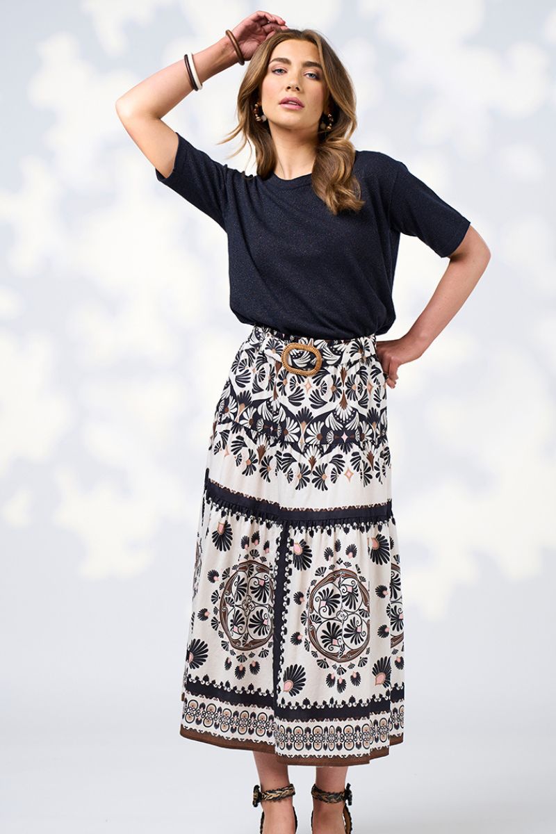 WOMAN IN TOP AND SKIRT WITN HAND ABOVE HER HEAD