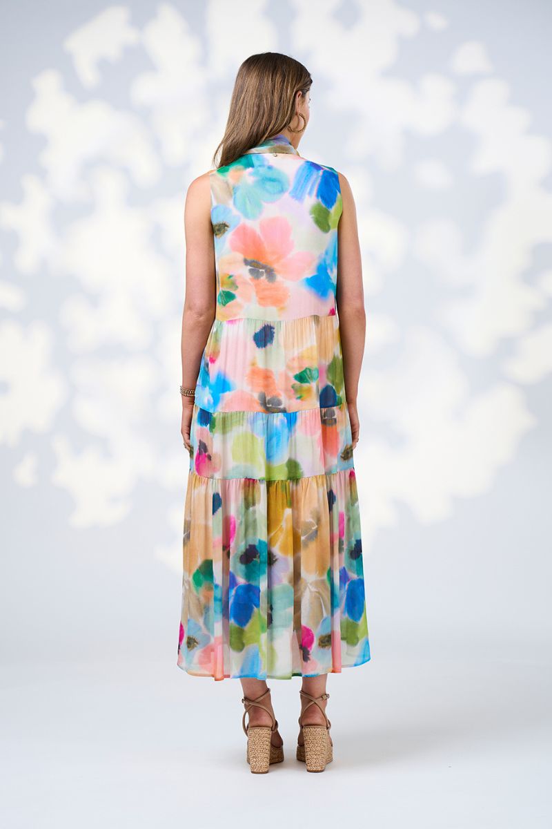 Woman wearing a colorful floral dress against a white background
