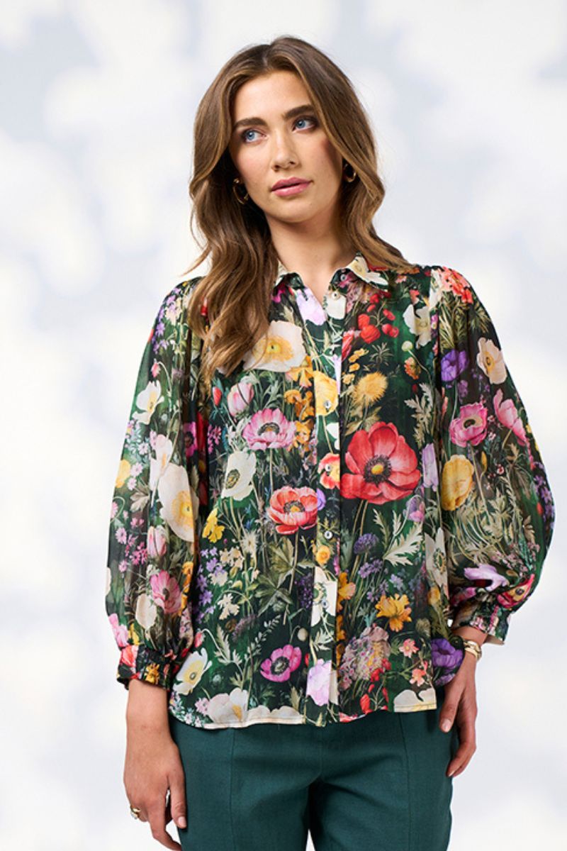 Front view of a Woman wearing a floral blouse with a white background