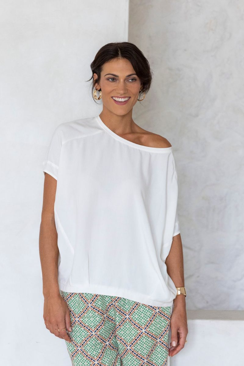 Woman wearing Lush Top by Humidity Lifestyle in cream styled off shoulder view HS25243
