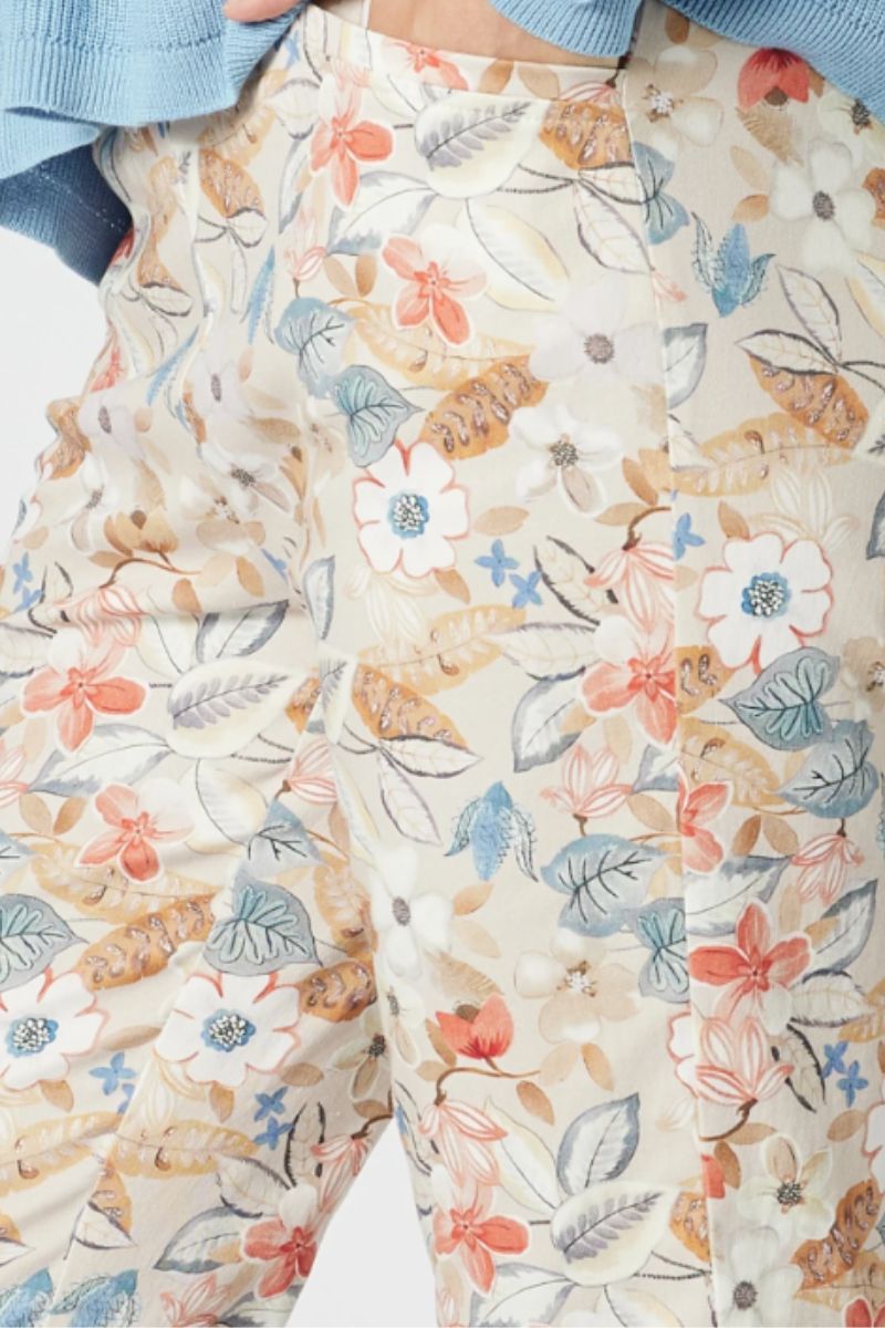 Floral patterned fabric with a patchwork design on a white background