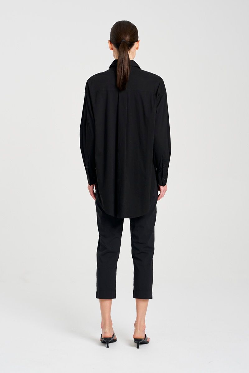 Back view of Person wearing a black coat and pants on a white background