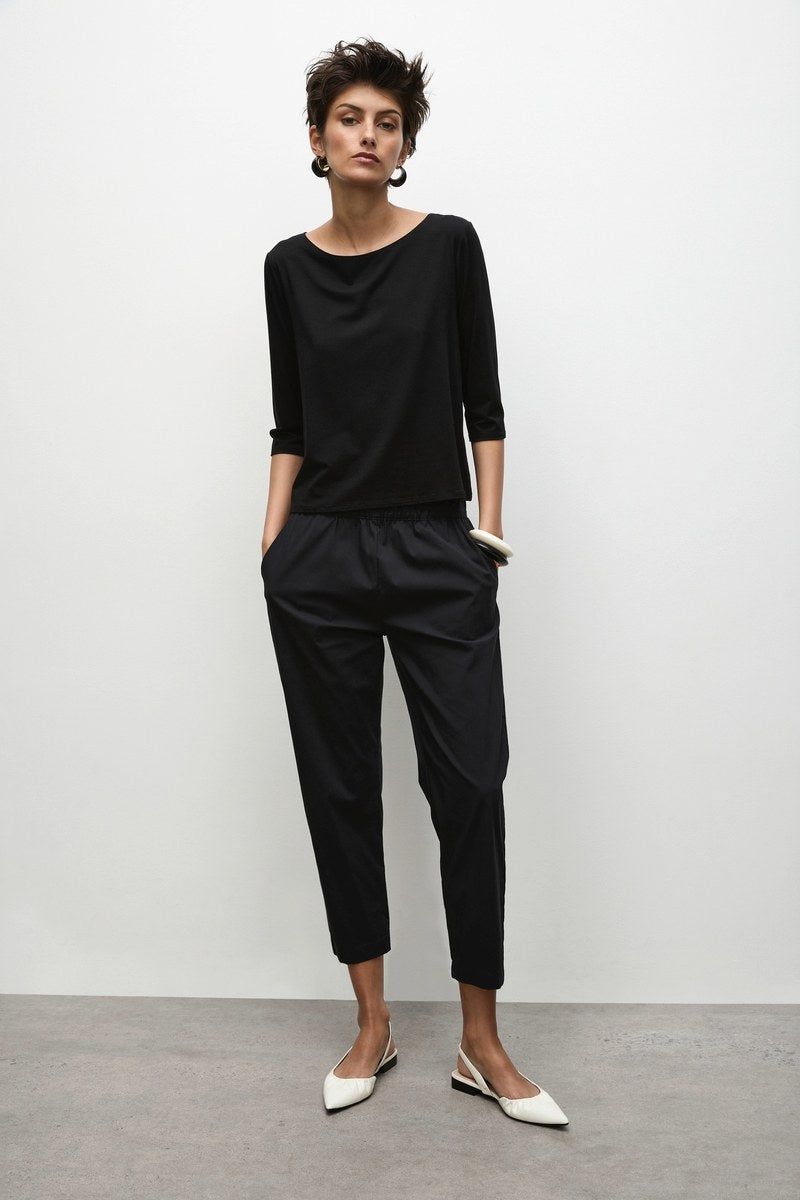 Woman wearing Mela Purdie Nomad Pants  F65 1548 in black and Mela Purdie Relaxed Boat Neck top F01 2630