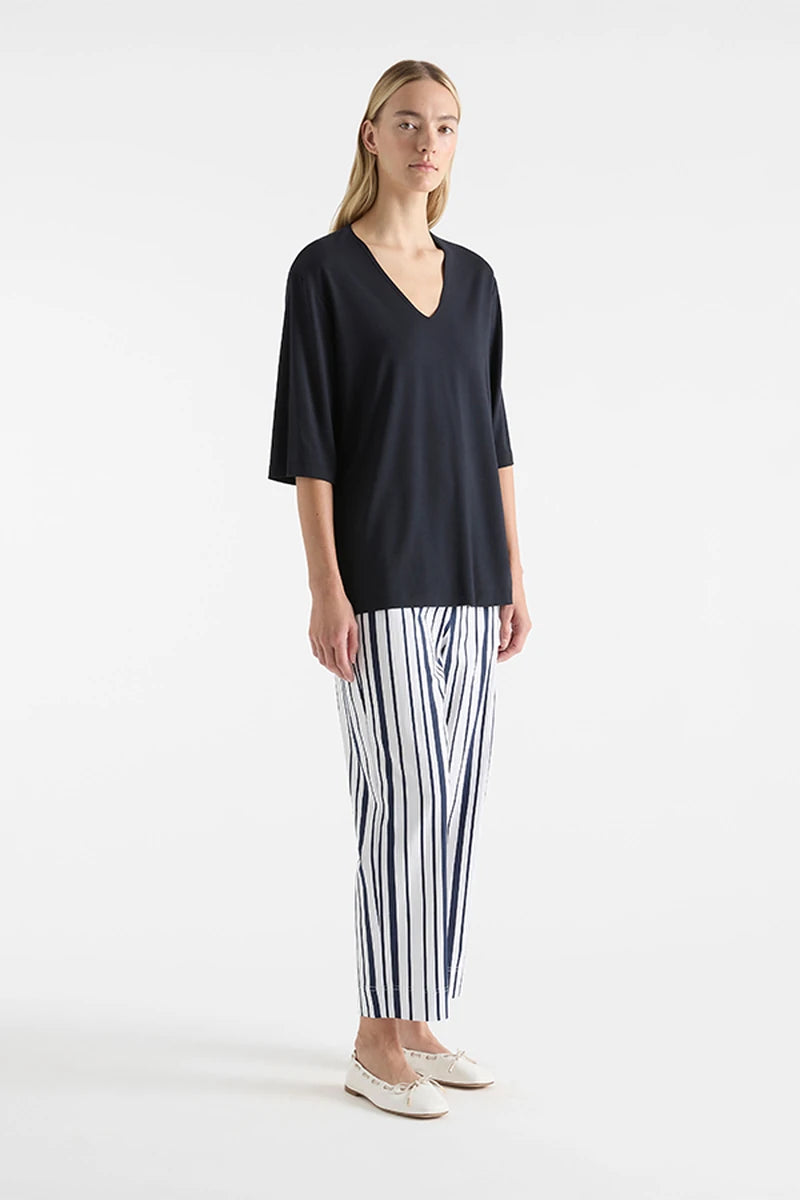 Mela Purdie V Stretch Plaza Navy F01 8323, angled front view showing V-neckline and loose elbow sleeves.