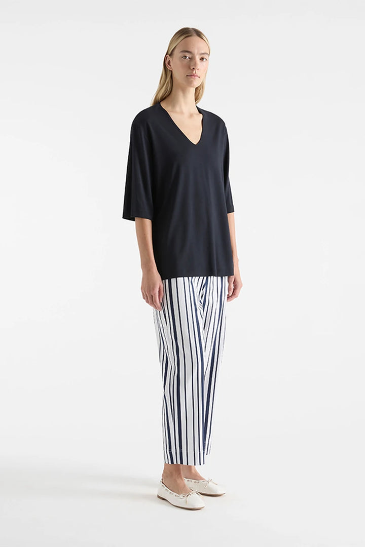 Mela Purdie V Stretch Plaza Navy F01 8323, angled front view showing V-neckline and loose elbow sleeves.