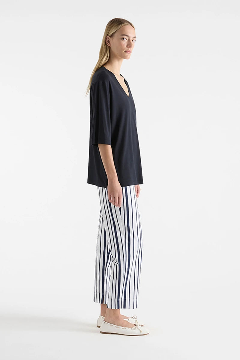 Mela Purdie V Stretch Plaza Navy F01 8323, side view showing relaxed body and straight hip-length hem.