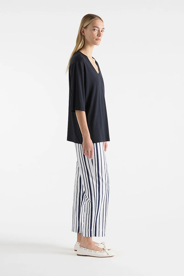 Mela Purdie V Stretch Plaza Navy F01 8323, side view showing relaxed body and straight hip-length hem.