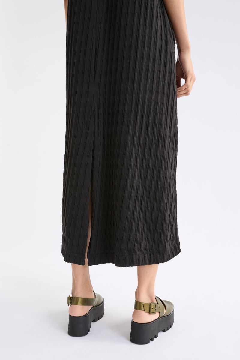 Close up of  black textured dress with a white background